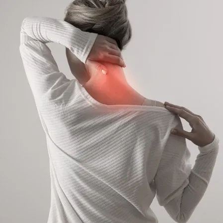 A woman with neck pain holding her neck with pain indicated in red